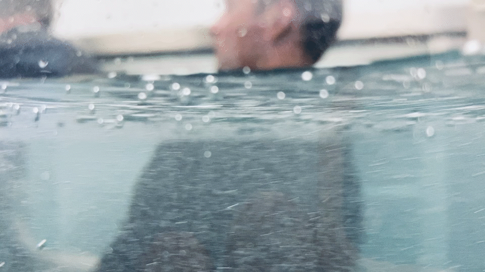 A physiotherapist and client using a hydrotherapy tank